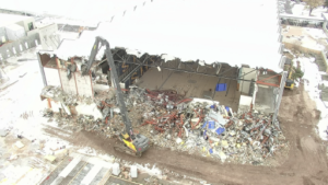 Demolition of gymnasium from auditorium.