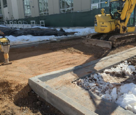 Sidewalk prep around the pool connecting the softball complex to the athletics building