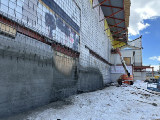 Shotcrete on existing exterior auditorium wall installed to provide structural resiliency and weather barrier